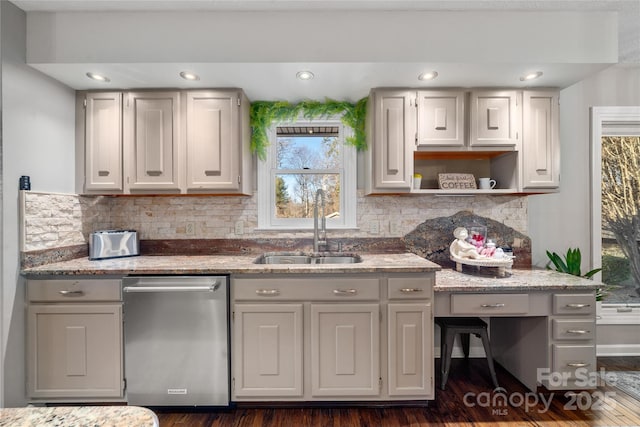 kitchen featuring light stone counters, sink, tasteful backsplash, and dishwasher