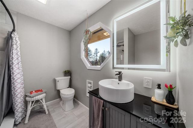 bathroom featuring vanity, a shower with curtain, and toilet