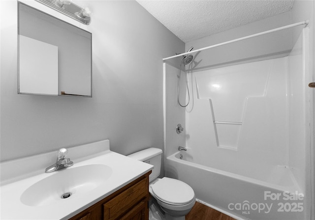 full bathroom featuring hardwood / wood-style floors, vanity, a textured ceiling, shower / bathtub combination, and toilet