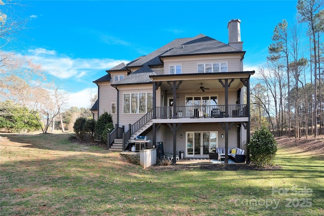 back of house with a yard, a chimney, stairway, a patio area, and ceiling fan