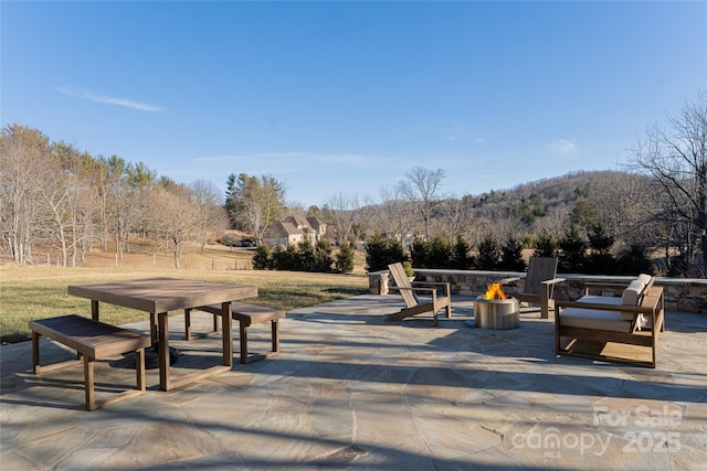 view of home's community featuring a mountain view and a patio area