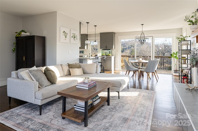 living room with wood-type flooring and a notable chandelier