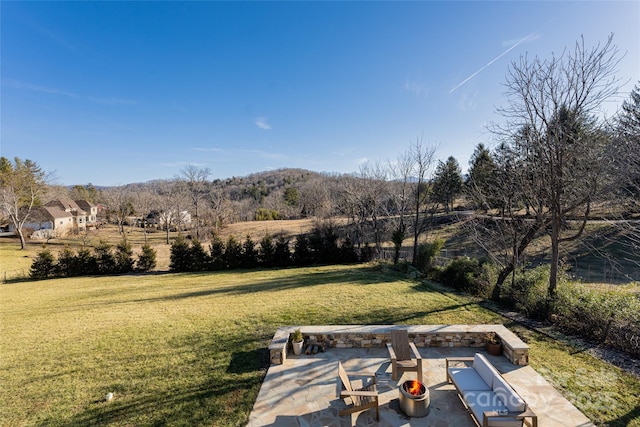 view of yard featuring a patio and a fire pit