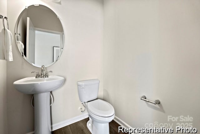 bathroom with sink, wood-type flooring, and toilet