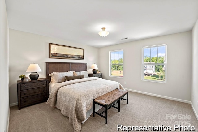 bedroom featuring light carpet