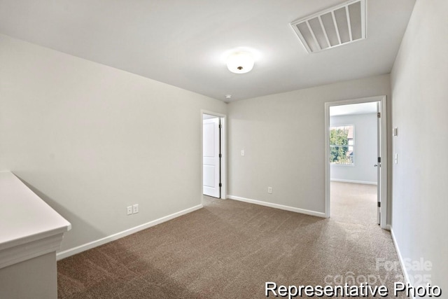 spare room featuring carpet flooring