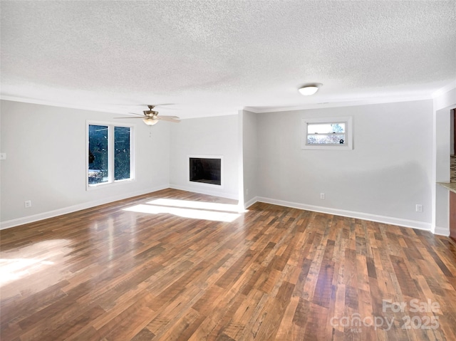 unfurnished living room with dark hardwood / wood-style floors, a textured ceiling, and ceiling fan