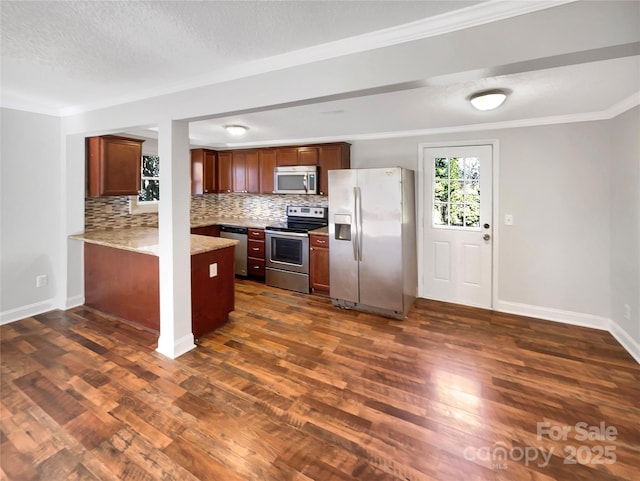 kitchen with dark wood-type flooring, stainless steel appliances, ornamental molding, decorative backsplash, and kitchen peninsula