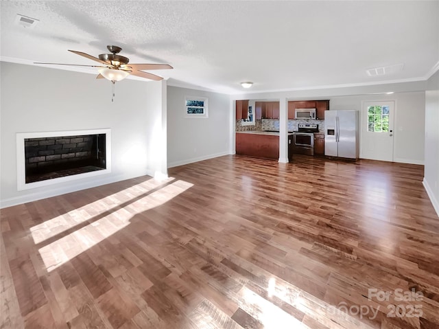 unfurnished living room with dark hardwood / wood-style floors, a textured ceiling, and ceiling fan