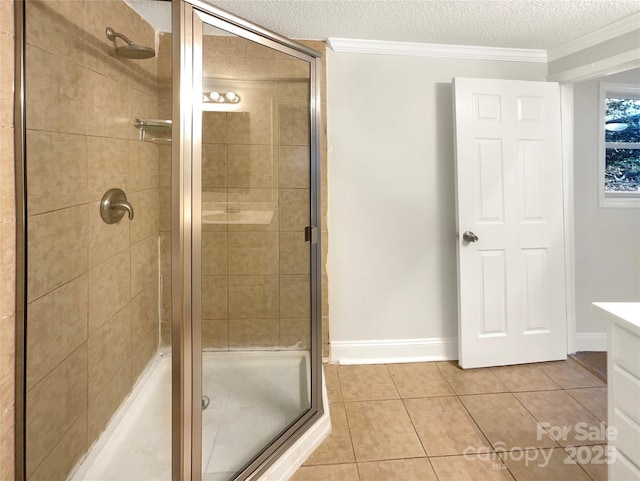 bathroom featuring vanity, ornamental molding, a textured ceiling, tile patterned floors, and walk in shower