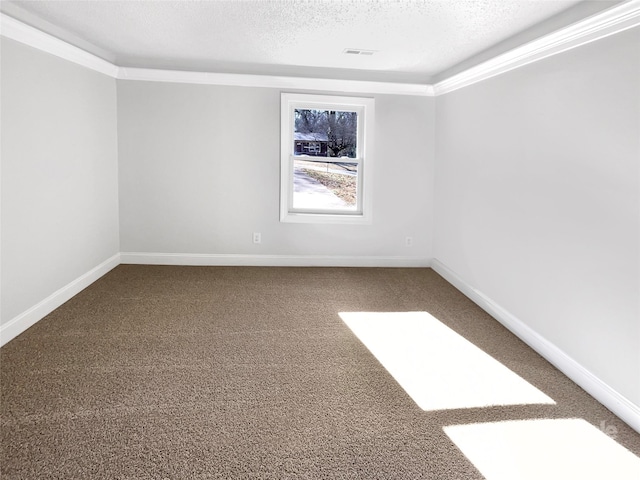 carpeted empty room featuring a textured ceiling