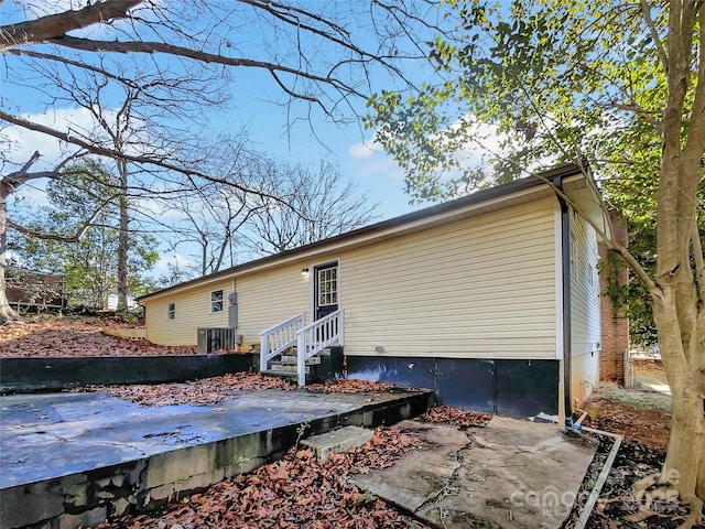 back of house with central AC unit