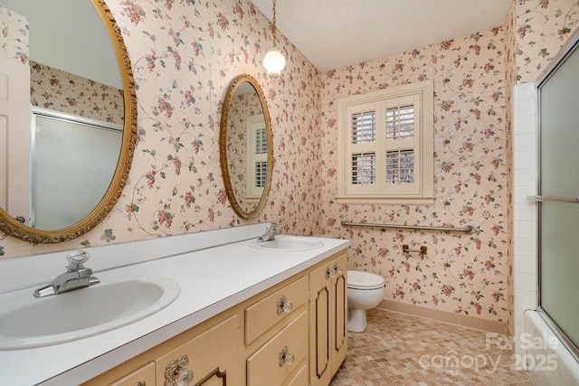 full bathroom with enclosed tub / shower combo, vanity, tile patterned flooring, and toilet