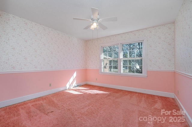 spare room with carpet floors and ceiling fan