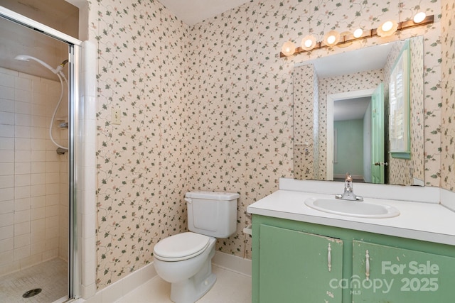 bathroom featuring vanity, a shower with shower door, tile patterned floors, and toilet