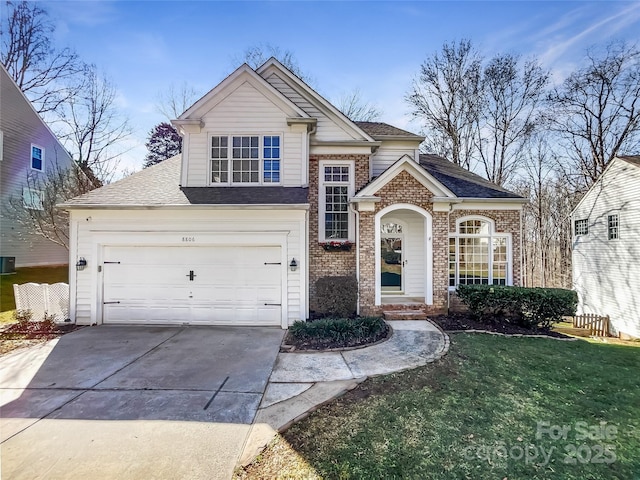 view of front property featuring a garage and a front lawn