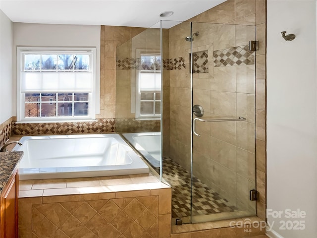 bathroom with vanity and separate shower and tub