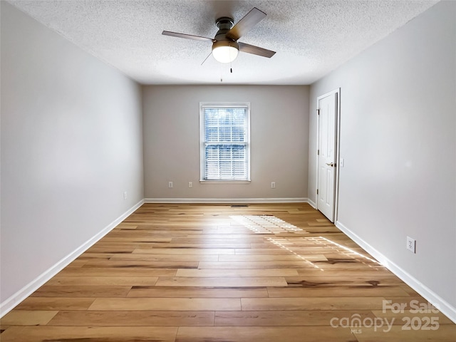 spare room featuring ceiling fan, a textured ceiling, and light hardwood / wood-style floors