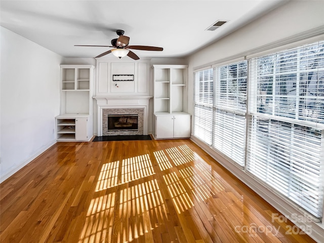 unfurnished living room with wood-type flooring and ceiling fan