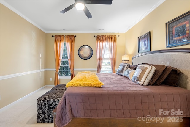 bedroom with crown molding, ceiling fan, and carpet flooring