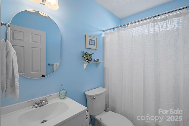 bathroom with vanity, walk in shower, a textured ceiling, and toilet