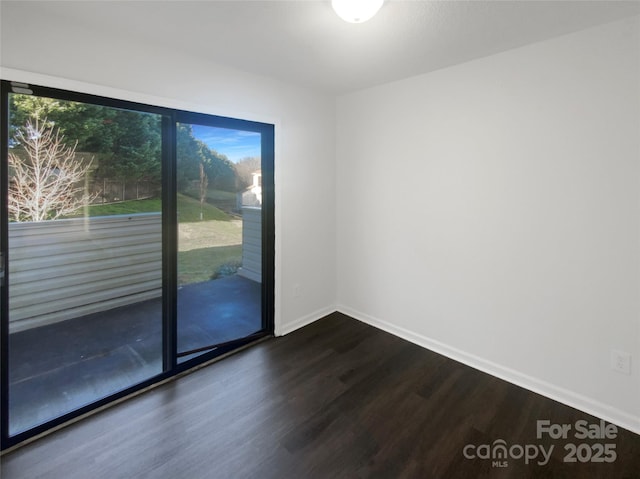 empty room featuring dark wood-type flooring