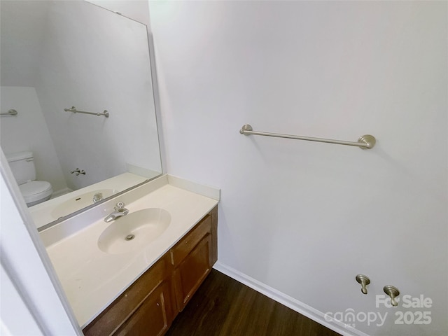 bathroom featuring vanity, toilet, and hardwood / wood-style floors