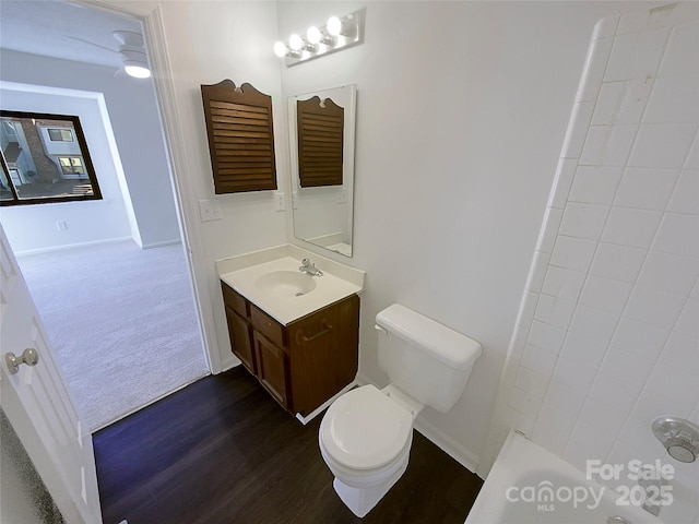 bathroom featuring vanity, toilet, hardwood / wood-style floors, and a shower