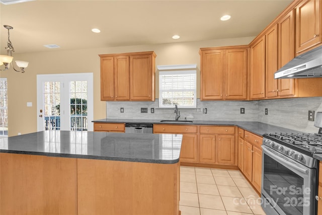 kitchen with a kitchen island, appliances with stainless steel finishes, pendant lighting, sink, and light tile patterned floors