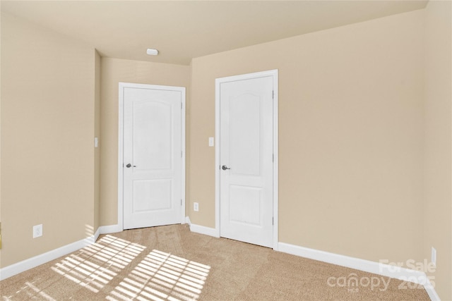 empty room with light colored carpet