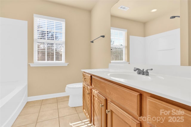 bathroom featuring a healthy amount of sunlight, toilet, tile patterned flooring, and vanity