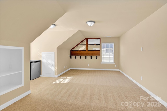 bonus room featuring lofted ceiling and light carpet