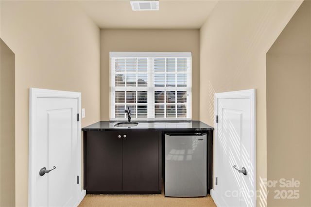 kitchen with stainless steel fridge and sink