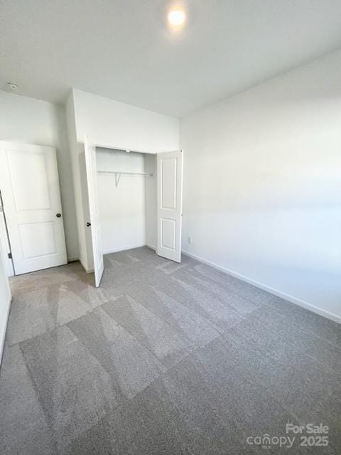 unfurnished bedroom with a closet and carpet