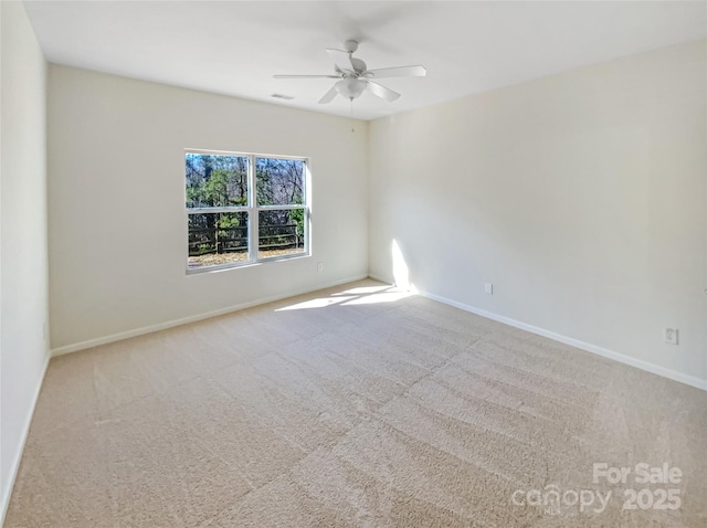 empty room with ceiling fan and carpet floors