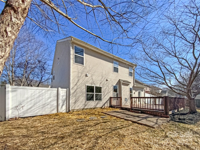 rear view of property featuring a deck