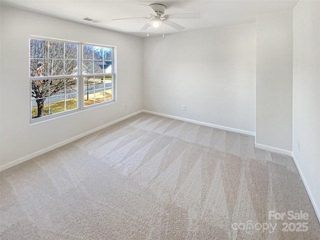 carpeted spare room with ceiling fan