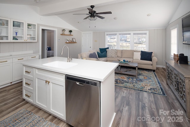 kitchen with white cabinets, a kitchen island with sink, vaulted ceiling with beams, and stainless steel dishwasher