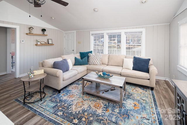 living room featuring ceiling fan, lofted ceiling, and wood-type flooring