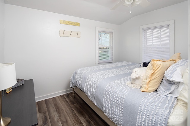 bedroom with ceiling fan, vaulted ceiling, and dark hardwood / wood-style floors