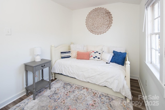 bedroom with hardwood / wood-style floors and lofted ceiling