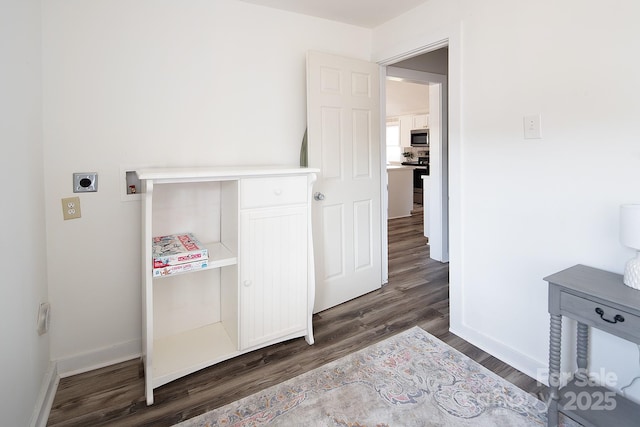 washroom with dark hardwood / wood-style flooring, hookup for a washing machine, and hookup for an electric dryer