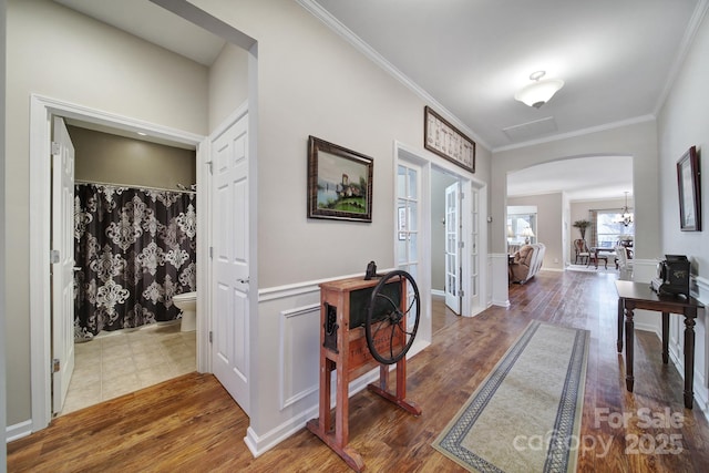 foyer entrance with crown molding, dark hardwood / wood-style floors, and a chandelier