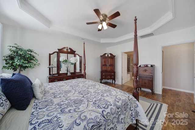 bedroom with a raised ceiling, ornamental molding, hardwood / wood-style floors, and ceiling fan