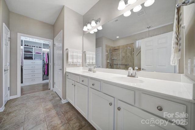 bathroom featuring vanity and an enclosed shower