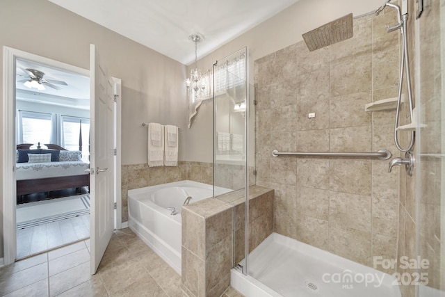 bathroom featuring tile patterned floors, separate shower and tub, and ceiling fan with notable chandelier