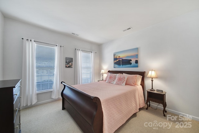 carpeted bedroom featuring multiple windows