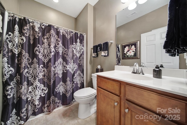 bathroom featuring tile patterned flooring, vanity, and toilet