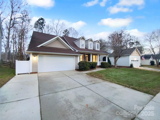 view of front of property with a garage, covered porch, and a front yard