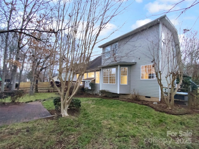 rear view of property featuring a lawn and a patio